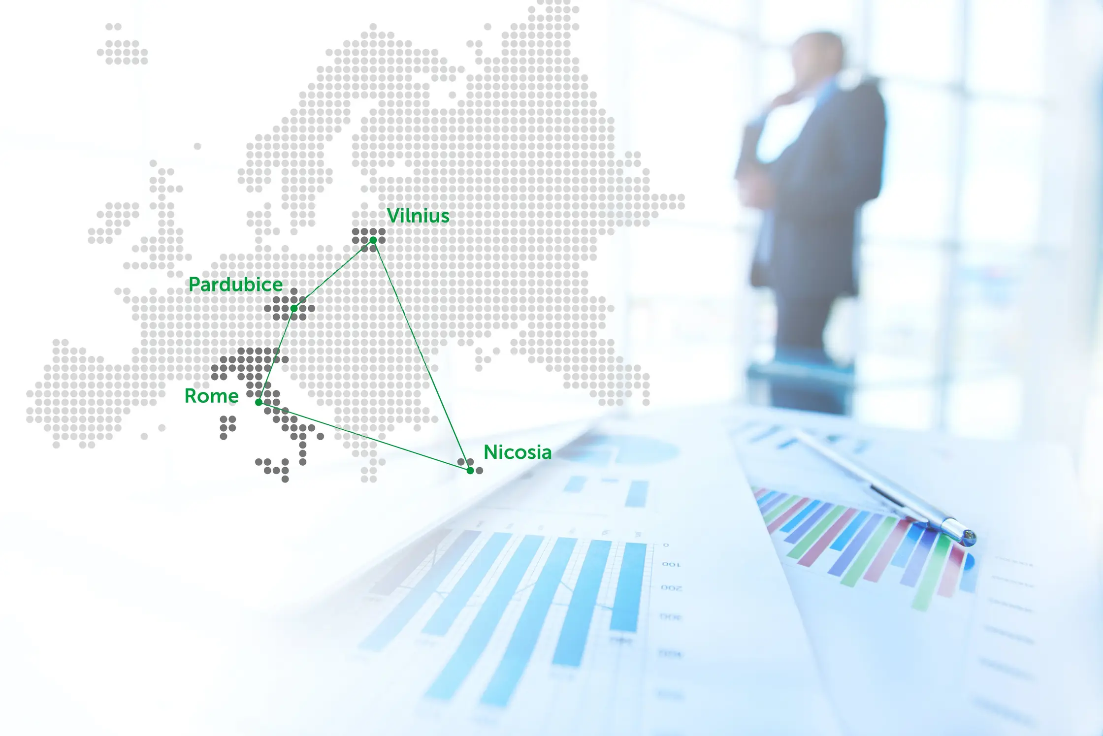 A man dressed in a business suit stands in front of a European map, meticulously studying a business graph.
